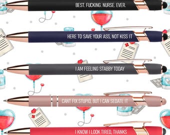 May include: A collection of five pens with rose gold accents and black ink. Each pen has a different message: "BEST. FUCKING. NURSE. EVER.", "HERE TO SAVE YOUR ASS, NOT KISS IT", "I AM FEELING STABBY TODAY", "CANT FIX STUPID, BUT I CAN SEDATE IT", and "I KNOW I LOOK TIRED, THANKS".