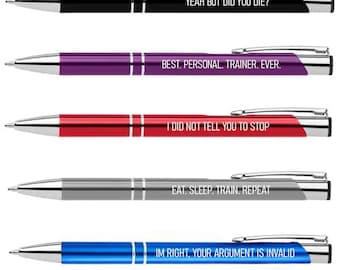 May include: Five ballpoint pens in black, purple, red, gray, and blue. Each pen has a silver clip and accents. The pens have the following text: "YEAH BUT DID YOU DIE?", "BEST. PERSONAL. TRAINER. EVER.", "I DID NOT TELL YOU TO STOP", "EAT. SLEEP. TRAIN. REPEAT", and "IM RIGHT, YOUR ARGUMENT IS INVALID".