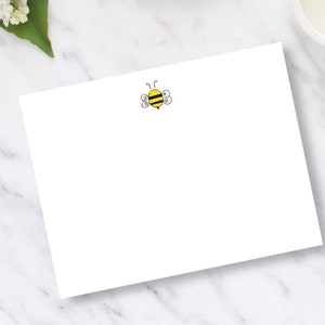 May include: A blank white card with a small yellow and black bee illustration in the upper right corner.