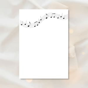 May include: White rectangular paper with a black musical staff and notes across the top. The notes are in various shapes and sizes, creating a flowing, wave-like pattern. The background is a soft, neutral color.
