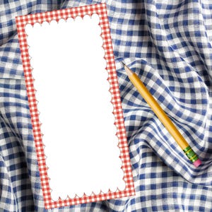 May include: A blank white notepad with a red and white gingham border sits on a blue and white checkered fabric. A yellow pencil with a pink eraser rests on the fabric, next to the notepad.