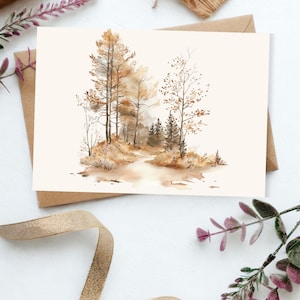 May include: A rectangular greeting card featuring a watercolor illustration of a forest scene with tall trees, sparse foliage, and a winding path in shades of brown, tan, and beige. The artwork is centered on a plain, light-colored card stock.