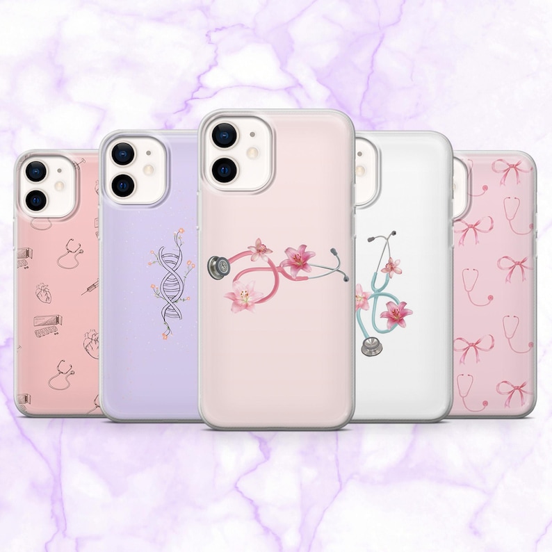 May include: Five phone cases with clear edges, each displaying a unique design. The cases showcase medical-themed illustrations, including a stethoscope with pink flowers, a DNA strand, and other medical symbols in pink and white. The cases are aligned.