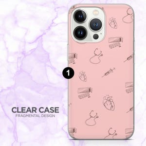 May include: A clear phone case featuring a pink backdrop adorned with a repeating pattern of medical illustrations, such as hearts, stethoscopes, syringes, and pill packs. The case has the text "CLEAR CASE FRAGMENTAL DESIGN".