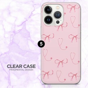 May include: A clear phone case with a pink background featuring a pattern of pink bows and stethoscopes. The case has a Fragmental Design and the text "CLEAR CASE" is visible.