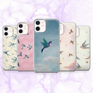 May include: Five clear phone cases with bird-themed designs. One case shows a hummingbird in flight against a blue sky. Other cases display swallows and stars on pink, cream, and blue backgrounds. The cases are designed for a smartphone.
