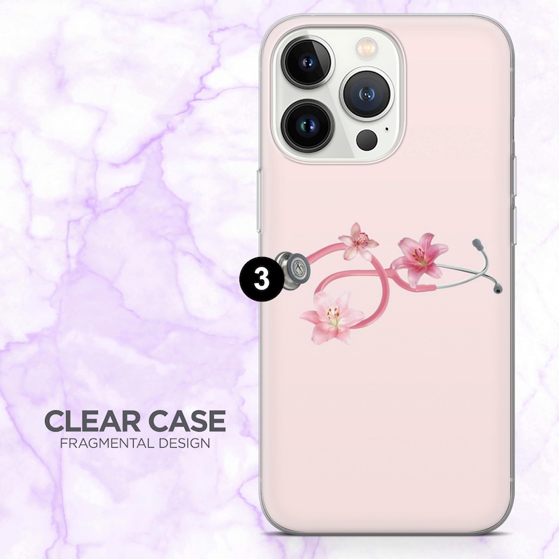 May include: A clear phone case with a pink background and a floral stethoscope design. The stethoscope is pink with silver accents and features pink lily flowers. The text "CLEAR CASE FRAGMENTAL DESIGN" is at the bottom.