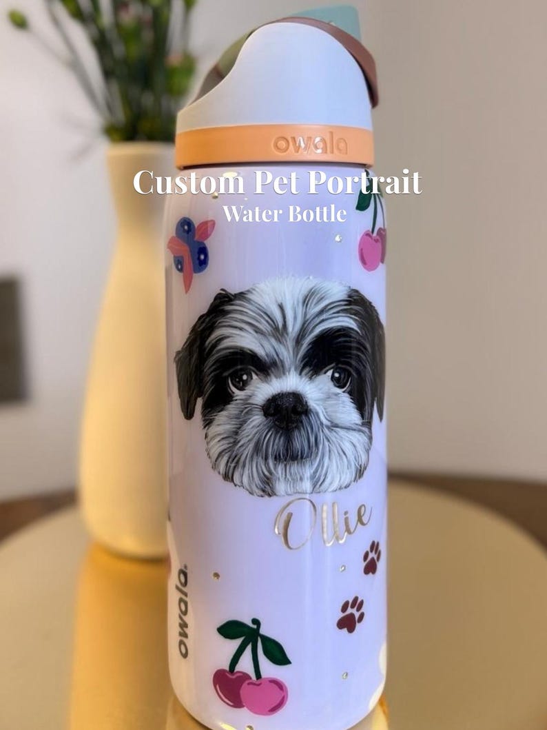 May include: A white ceramic mug with a black handle and the text "But First, Coffee" in a bold, black font. The mug is set against a blurred background, suggesting a cozy setting.