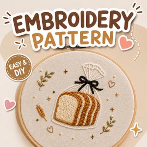 May include: An embroidery pattern in a wooden hoop featuring a loaf of sliced bread in a clear bag tied with a black bow. The design includes small wheat stalks, hearts, and floral sprigs. Text reads EMBROIDERY PATTERN and EASY & DIY.