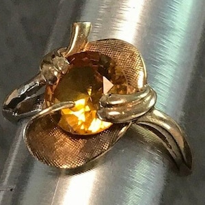 A vintage 14kt yellow man made I believe yellow sapphire ring.  Size 6 1/2