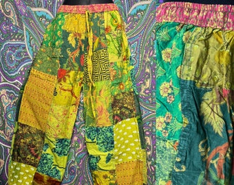May include: Patchwork pants with a green, yellow, and pink floral pattern. The pants have an elastic waistband and a drawstring.