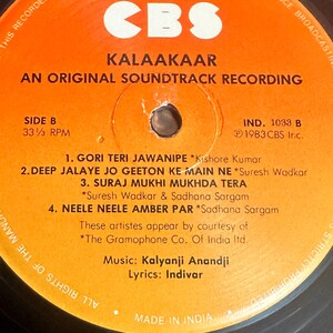 May include: Close-up of a vintage vinyl record labeled "Kalaakaar: An Original Soundtrack Recording" by CBS. The orange label features song titles and artist credits. The record is Side B, 33 1/3 RPM, and Made in India.