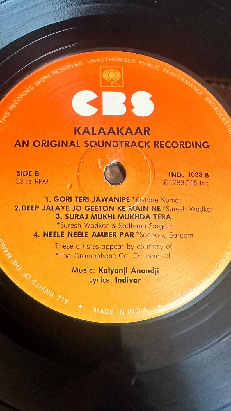 May include: Close-up of a vintage vinyl record labeled "Kalaakaar: An Original Soundtrack Recording" by CBS. The orange label features song titles and artist credits. The record is Side B, 33 1/3 RPM, and Made in India.