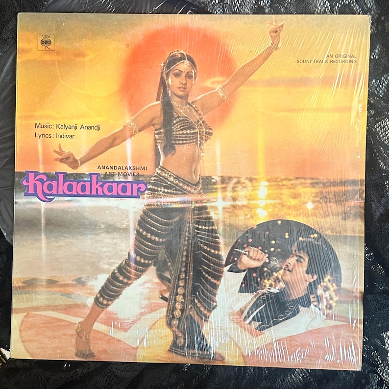 May include: Sealed vinyl record album titled "Kalaakaar" with a woman in traditional Indian attire on the cover. The album art features a sunset backdrop and text indicating the music and lyrics.