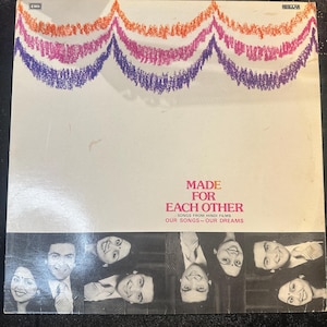 May include: Vintage vinyl record album cover for "Made For Each Other." The cover has a white background with colourful, wavy crayon-like lines at the top. The title is in pink and the bottom has black and white photos of people.