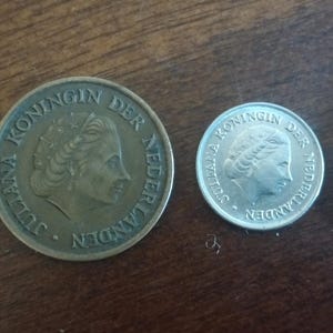 May include: Four vintage Dutch coins of varying sizes are arranged in a row. The coins are silver and bronze in color, with the text "KONINGIN DER NEDERLANDEN" visible on each. The coins are displayed on a wooden surface. The text "Type 1 Bundle" is at the bottom.