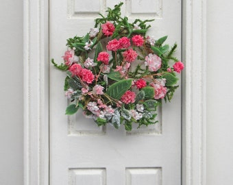 Miniature Wreath Flowing with Flowers in Shades of Pink