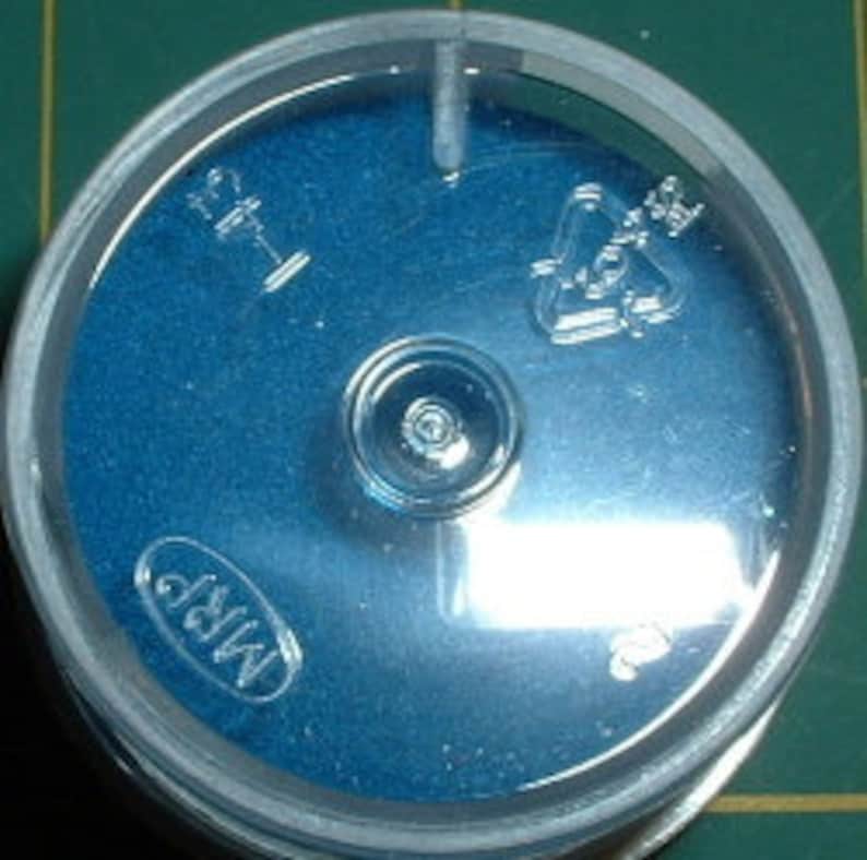 May include: A blue plastic container with a clear lid. The lid has a recycling symbol and the number 1. The container has the word "MRP" printed on it.