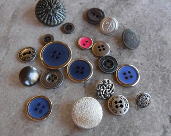 May include: Assortment of buttons in various colors, shapes, and sizes.  The buttons are made of metal, plastic, and fabric.  Some buttons have a textured surface, while others are smooth.  There are round, square, and oval buttons.