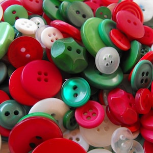 May include: A collection of red, green, and white buttons in various sizes and shapes. The buttons are made of plastic and have a shiny finish.