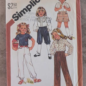May include: Simplicity sewing pattern for children's clothing, featuring illustrations of various outfits. The cover includes the text "CHILD 5633" and "$2.50 U.S.A.". The pattern includes a bonus chart for working with plaids.