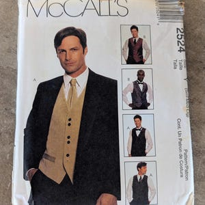 May include: A McCall's sewing pattern envelope featuring a man in a black suit with a gold vest and tie. The envelope includes images of different vest styles and the text "MCCALL'S" and "2524".