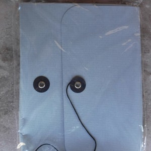 May include: A light blue accordion keeper with black string and two black buttons. The keeper is made by Bazzill Basics Paper and is acid and lignin free. It contains one box and a six-panel 6 x 4 accordion-folded insert.