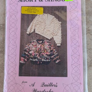 May include: A pink pattern packet titled "SHORT & SHAGG" featuring images of two jackets. One jacket is cream-colored with a ruffled design, and the other is a floral print. The packet is from "A Quilter's Wardrobe."