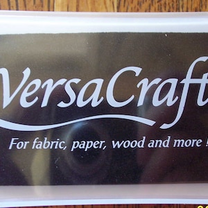May include: A black ink pad with a white label that reads "VersaCraft&trade; For fabric, paper, wood and more!"