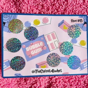 May include: A light pink and blue card with holographic circles and bubble gum graphics. The card has the text "Bubble Gum" and "Save $45". The card is on a pink, textured surface.