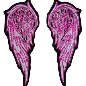 May include: A pair of embroidered patches shaped like wings, featuring a black base with intricate stitching in vibrant hot pink and white thread. The design displays layered feather patterns with a distinct outline, creating a symmetrical set.