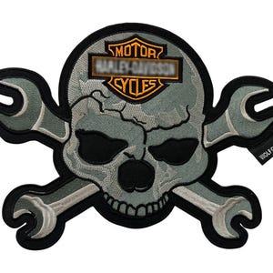 May include: Embroidered patch featuring a skull with crossed wrenches, in shades of gray, black, and white. The patch includes the Harley-Davidson logo and the text "WOLF CLAW US".