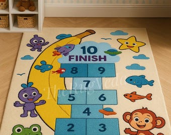 May include: A whimsical hopscotch rug featuring a yellow banana design with numbers 1-10. The rug includes cartoon characters like a frog, monkey, and fish. The word "FINISH" is at the end of the hopscotch path. The rug is cream-colored.