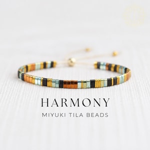 May include: A bracelet featuring a repeating pattern of rectangular Miyuki Tila beads in metallic copper, matte black, and iridescent light blue. The bracelet includes an adjustable cord closure with small gold-toned beads. Text reads HARMONY MIYUKI TILA BEADS.