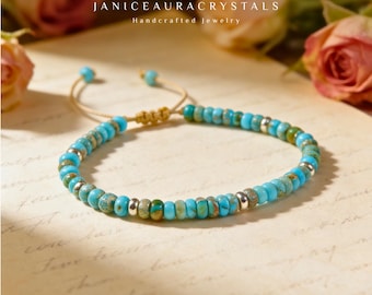 May include: Turquoise beaded bracelet with silver accents. The bracelet is on a beige cord with adjustable knots. The background includes roses and the text "JANICEAURACRYSTALS Handcrafted Jewelry."