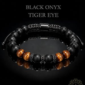 May include: A beaded bracelet featuring matte black onyx spheres and brown tiger eye stones, accented with small black metal spacers embedded with tiny black crystals. The text BLACK ONYX TIGER EYE is displayed above the bracelet.