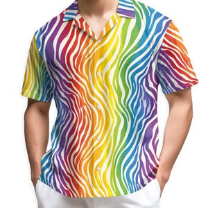 May include: A short-sleeved button-down shirt with a vibrant rainbow zebra stripe pattern. The shirt features a classic collar and a relaxed fit. The colorful design includes red, orange, yellow, green, blue, and purple stripes on a white background.