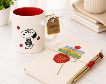 Juego de taza y cuaderno de Snoopy de Peanuts de Rae Dunn, taza de café de 473 ml con bolígrafo.