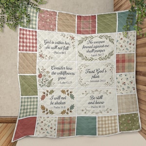 May include: A patchwork quilt with squares in red, green, beige, and floral patterns. The quilt has six rectangular panels with Bible quotes, framed with floral and leaf designs. The quotes include 'God is within her' and 'Be still and know'.