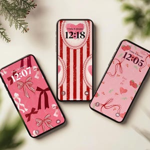 May include: Three smartphones displaying Valentine's Day-themed wallpapers. The screens show pink and red designs with bows, hearts, and strawberries. The time is displayed on each screen. The overall theme is love and romance.