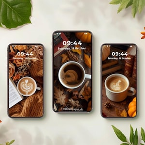 May include: Three smartphones displaying autumn-themed wallpapers. Each screen shows a coffee cup with latte art, surrounded by fall foliage, books, and pumpkins. The time displayed is 09:44, Saturday, October 18.
