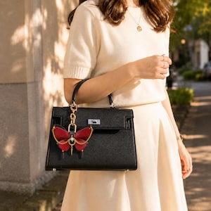 This Burgundy Gothic Vintage Leather Butterfly Bag Charm is a handmade purse charm and handbag charm, crafted from horsehair and lambskin, with gold chain, moon, and star details, also works as a keychain or car mirror pendant.