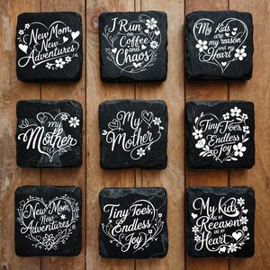Peut inclure: Un ensemble de neuf dessous de verre carr&eacute;s en ardoise noire avec des textes blancs imprim&eacute;s et des motifs de c&oelig;urs floraux. Les phrases incluent New Mom New Adventures, I Run on Coffee and Chaos, My Kids are my reason and my Heart, My Mother et Tiny Toes Endless Joy.