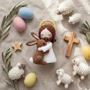 May include: A collection of handmade Easter decorations. The centerpiece is a crocheted figure of Jesus embracing a brown bunny. Surrounding them are crocheted sheep, wooden cross, star, and felt eggs in pastel colors. Olive branches add a natural touch.