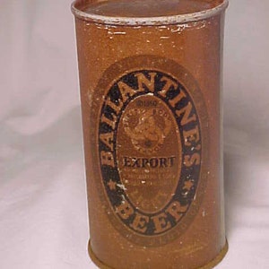 May include: A vintage brown metal can with a white top. The can has a black and gold label with the text "Ballantine's Export Light Beer" and a graphic of a man holding a beer stein.