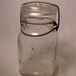 May include: A clear glass jar with a wire bail closure. The jar has the words "Royal" and "Fruit Jar" embossed on the side.