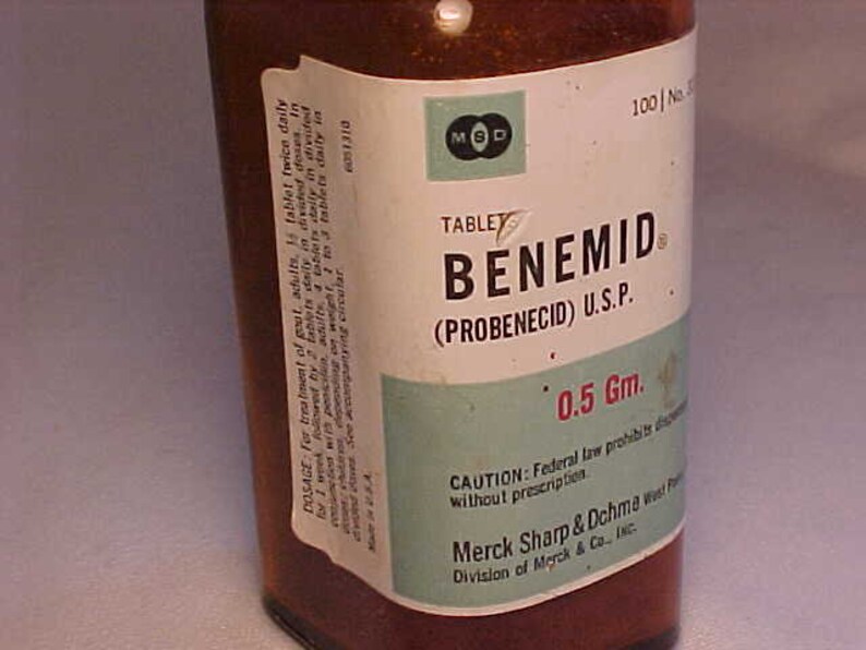 May include: A brown glass bottle with a white label that reads "BENEMID (PROBENECID) U.S.P. 0.5 Gm." The label also includes the text "CAUTION: Federal law prohibits dispensing without prescription" and "Merck Sharp & Dohme Division of Merck & Co., Inc."