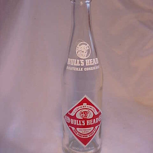 c1970s Bull's Head Ginger Ale Sherbrooke, Quebec, Canada ACL Painted Label Crown Top 10.6 Ounce clear glass Soda Bottle with a Bull Head