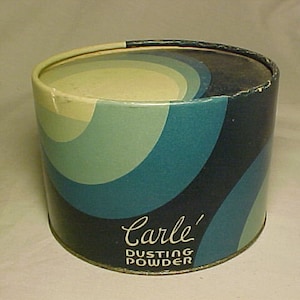 May include: A vintage blue and white cylindrical tin container with a swirling pattern. The text "Carle' Dusting Powder" is printed on the front.