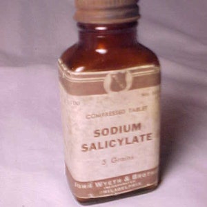 May include: A brown glass bottle with a rusty metal lid. The label reads "Sodium Salicylate 5 Grains John Wyeth & Brother Philadelphia".